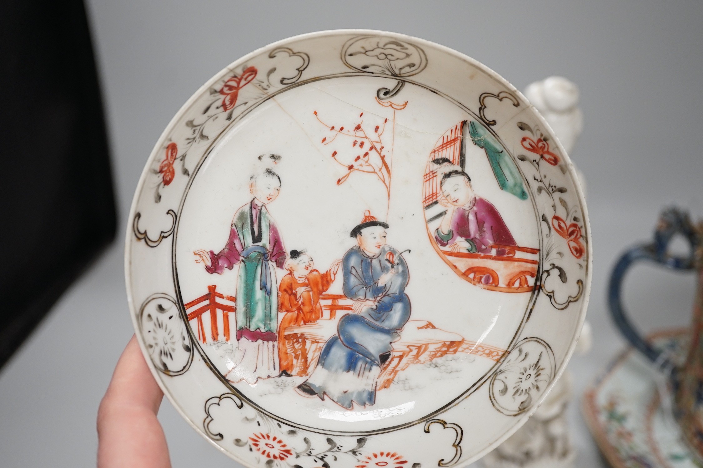 A Chinese figure of blanc de chine, a dragon tea bowl, a saucer, a large tankard, and another Chinese dish, tallest 23cm